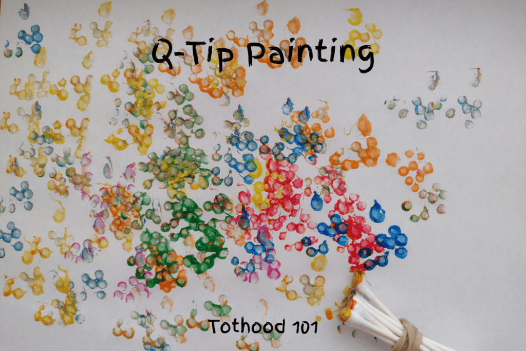 Q-tip painting activity done with blue, yellow, green, and red paint.