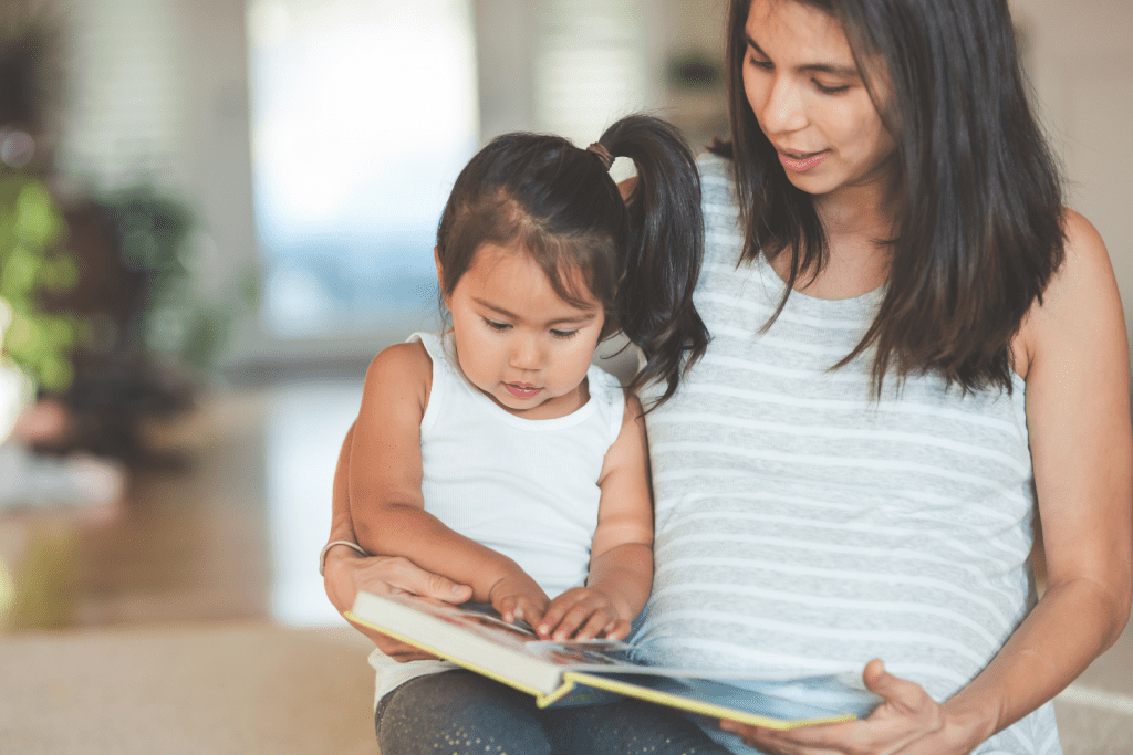 Fun ways to teach counting, a mom reading a book to her young daughter. 