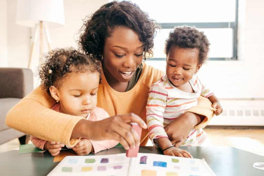Mom reading to two kids about shapes
