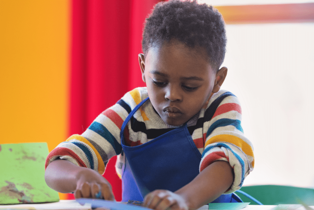 A preschool  boy doing an art project